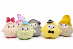 Row of colorful plush toys with various accessories on a white background