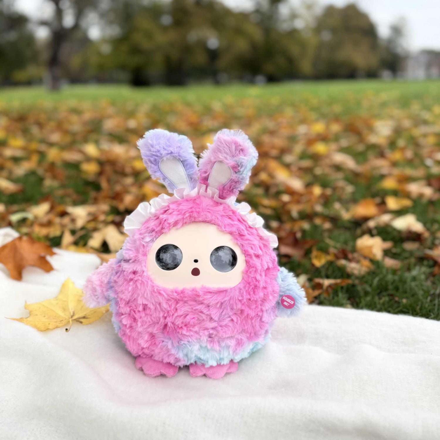 AI plush toy sitting on autumn leaves